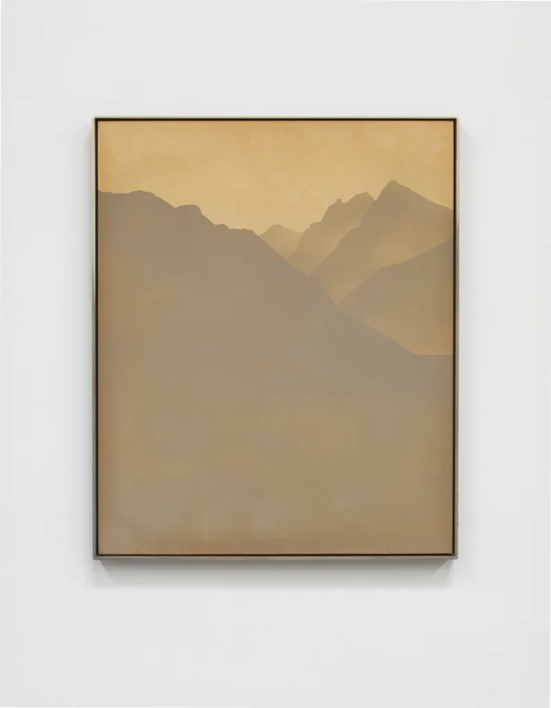 A small panel sandblasted aluminum piece that represents a mountain range and sky