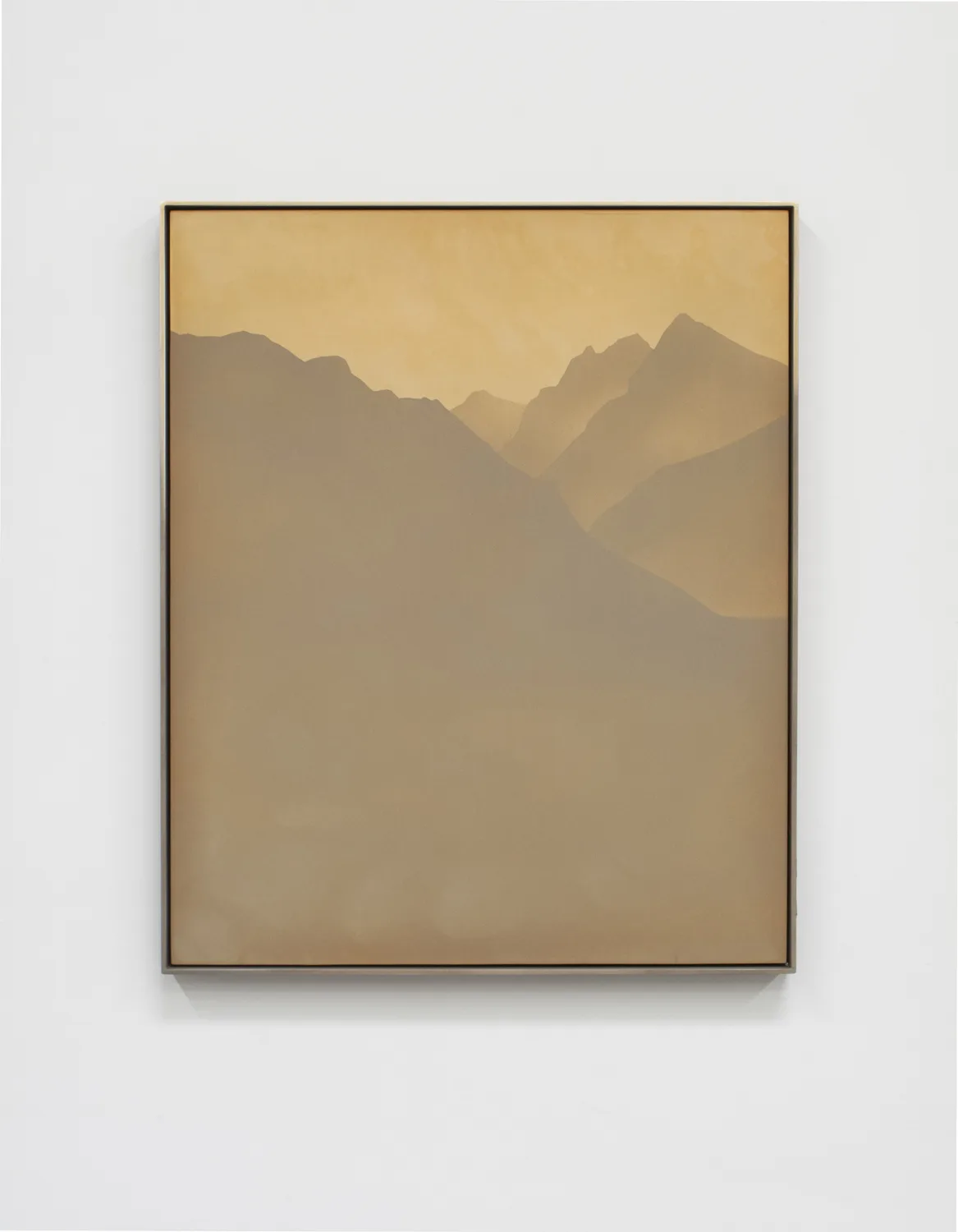 A small panel sandblasted aluminum piece that represents a mountain range and sky