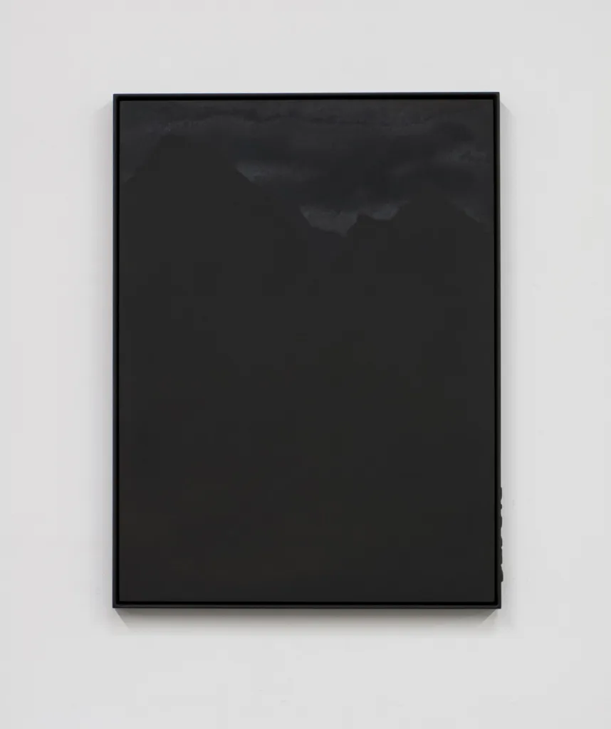 A small panel black steel plate piece that represents a mountain range and sky