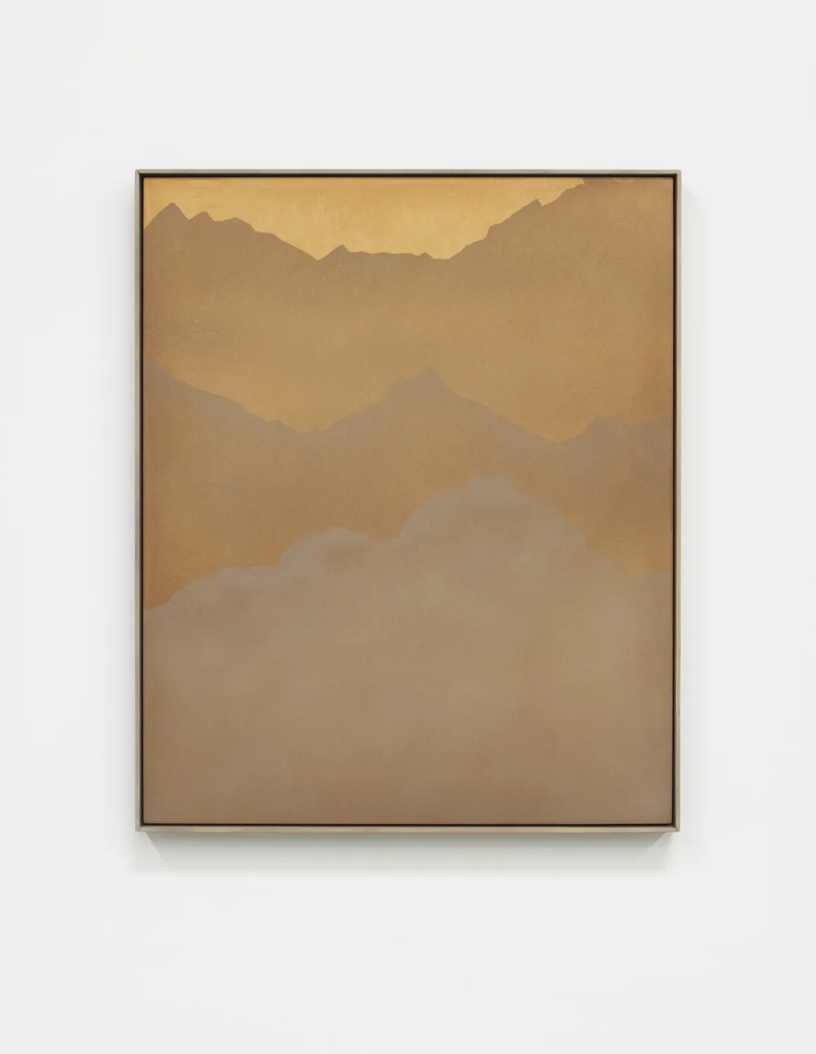 A small panel sandblasted aluminum piece that represents a mountain range and sky