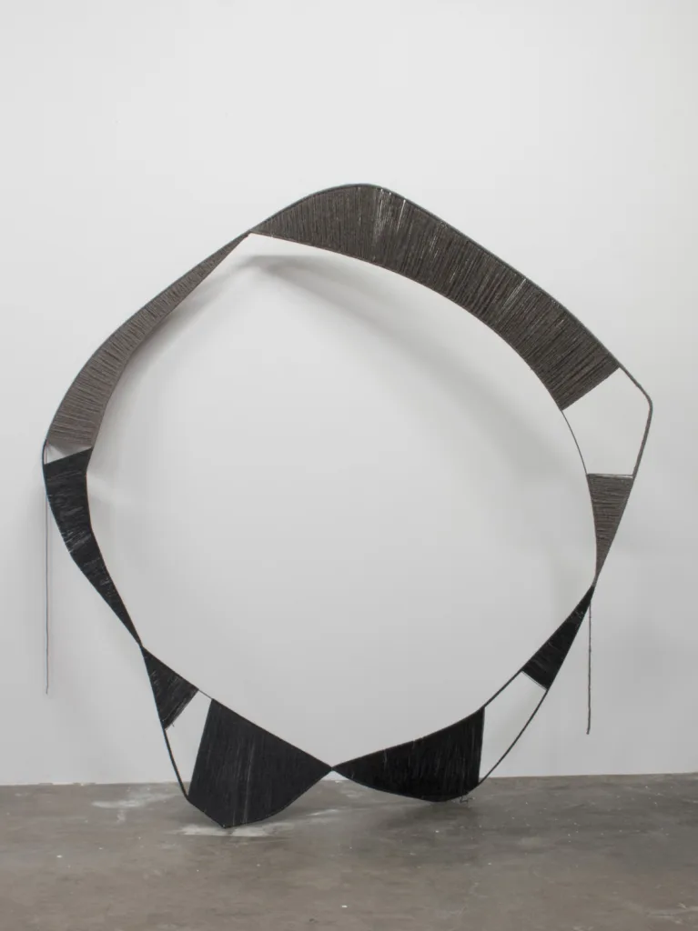 A sculpture that irregular steel hoops that black structures with spun white wool, contrasting soft and hard, warm and cool, and heavy and light