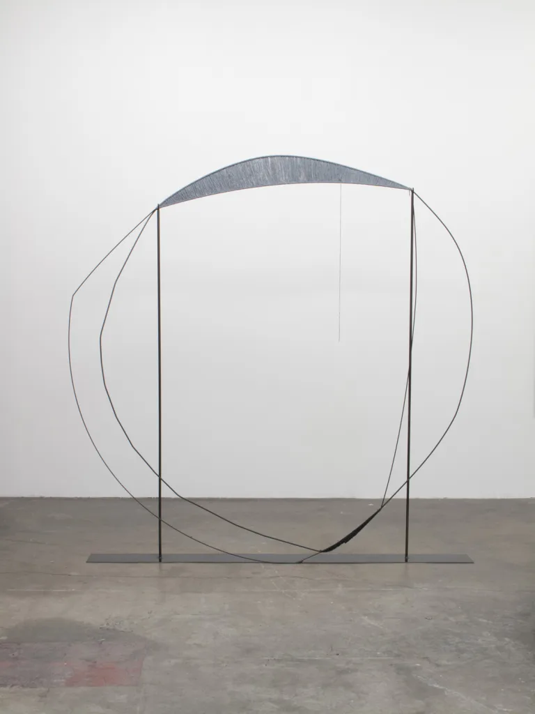 A sculpture that irregular steel hoops that steel structures with spun gray wool, contrasting soft and hard, warm and cool, and heavy and light