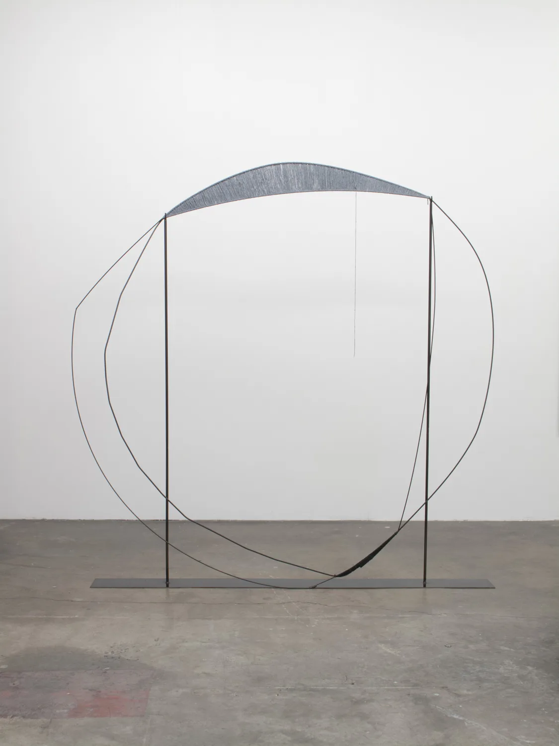 A sculpture that irregular steel hoops that steel structures with spun gray wool, contrasting soft and hard, warm and cool, and heavy and light