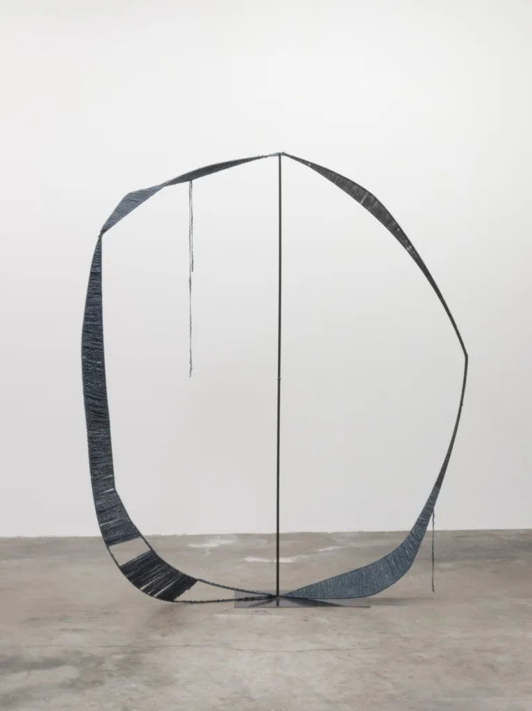 A sculpture that irregular steel hoops that steel structures with spun dark gray wool, contrasting soft and hard, warm and cool, and heavy and light