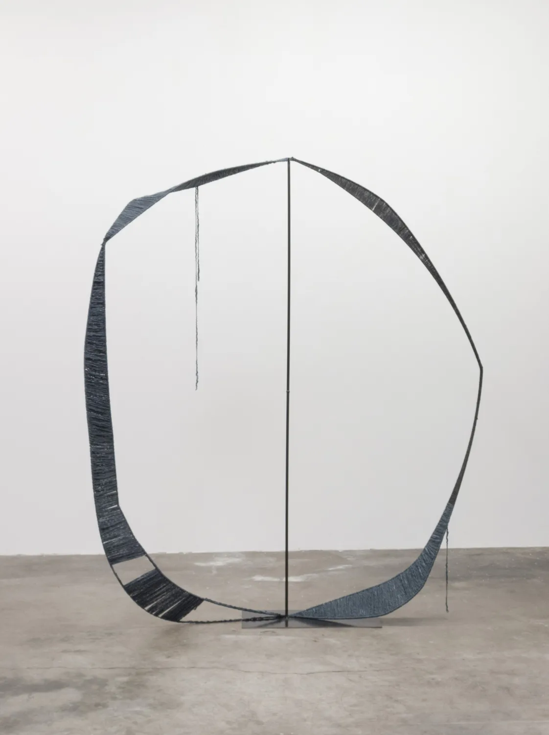 A sculpture that irregular steel hoops that steel structures with spun dark gray wool, contrasting soft and hard, warm and cool, and heavy and light