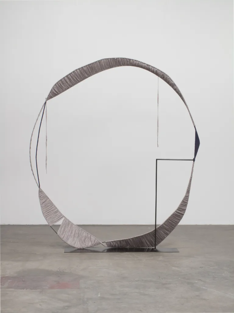 A sculpture that irregular steel hoops that steel structures with spun gray wool, contrasting soft and hard, warm and cool, and heavy and light