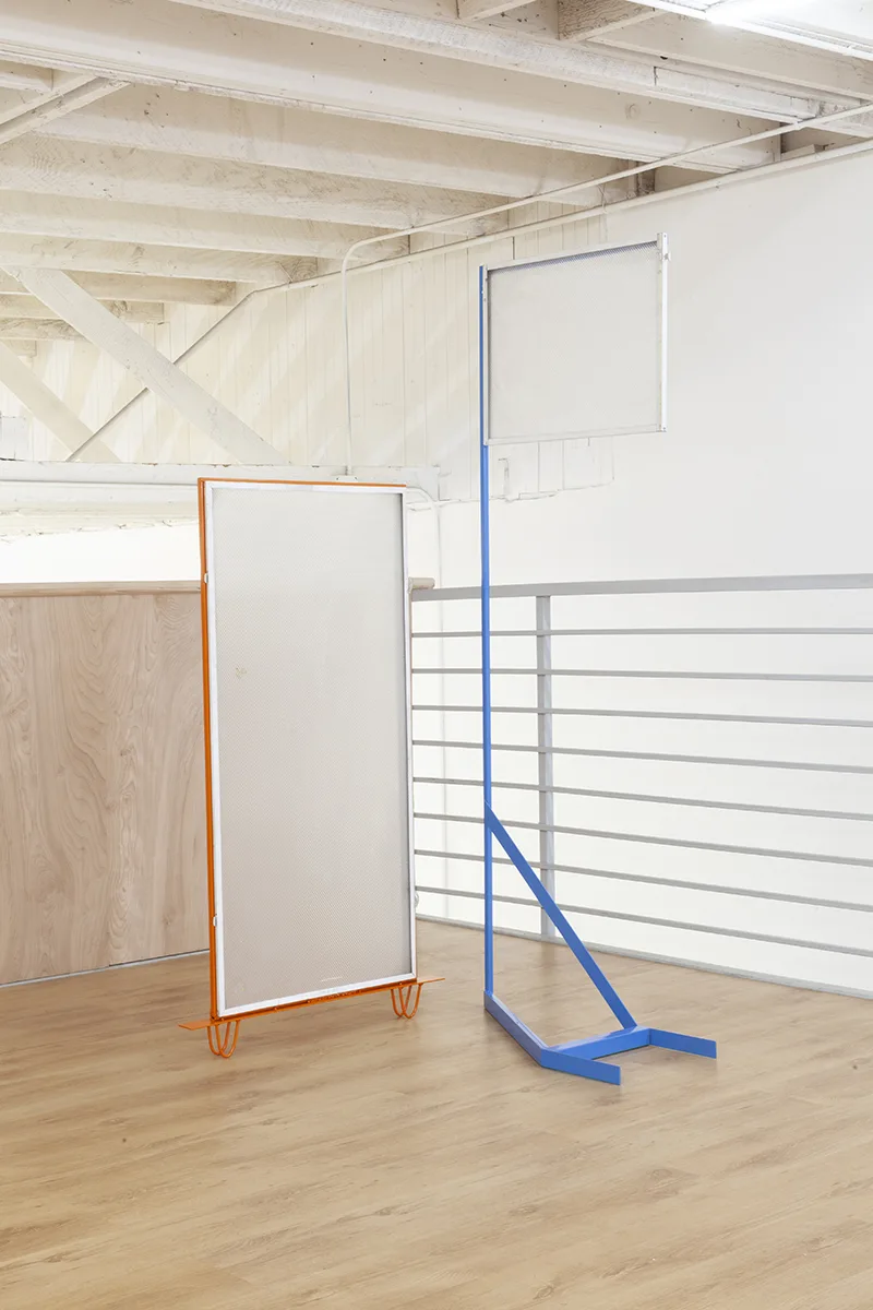 The discreet charm of the ostrich syndrome 1 by Tanya Brodsky, Powder coated steel, salvaged fluorescent light cover, 23 x 72 x 12 inches and The discreet charm of the ostrich syndrome 2 by Tanya Brodsky, Powder coated steel, salvaged fluorescent light cover, 24 x 51 x 2 inches