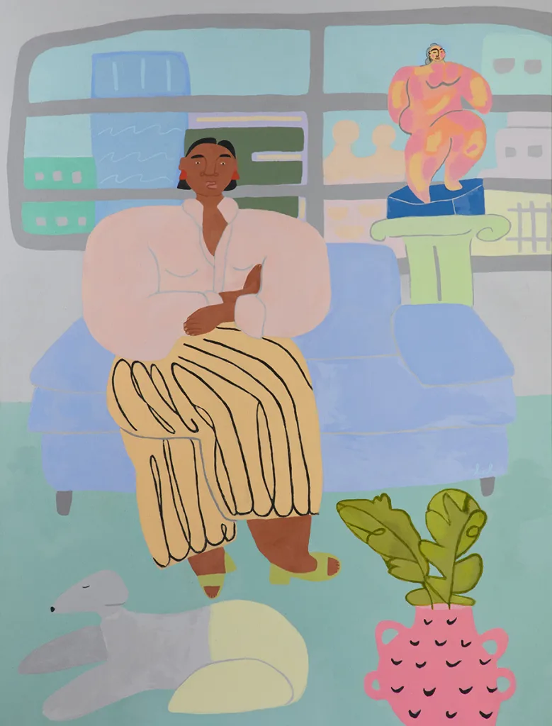 A lady is sitting on a blue couch and the dog is on the floor