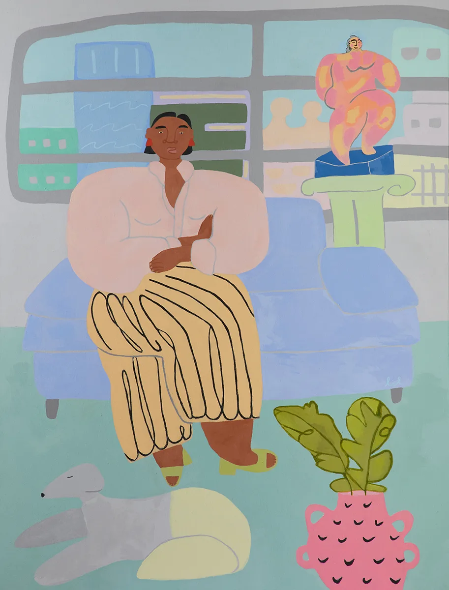 A lady is sitting on a blue couch and the dog is on the floor