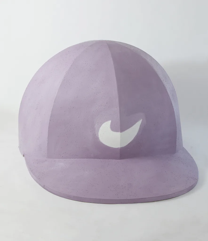 A sculpture that is shaped as a big baseball hat