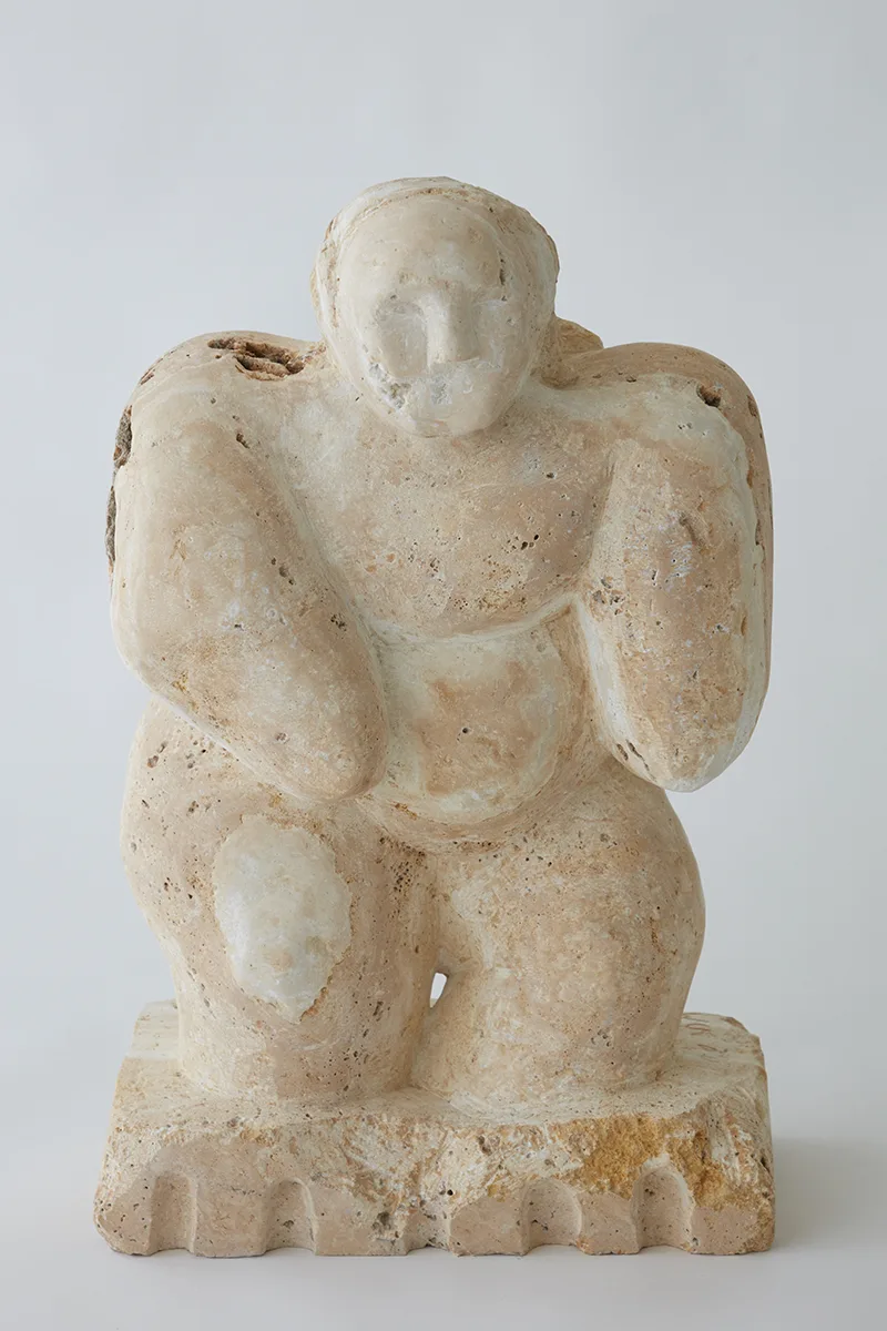 A white sculpture of a human figure