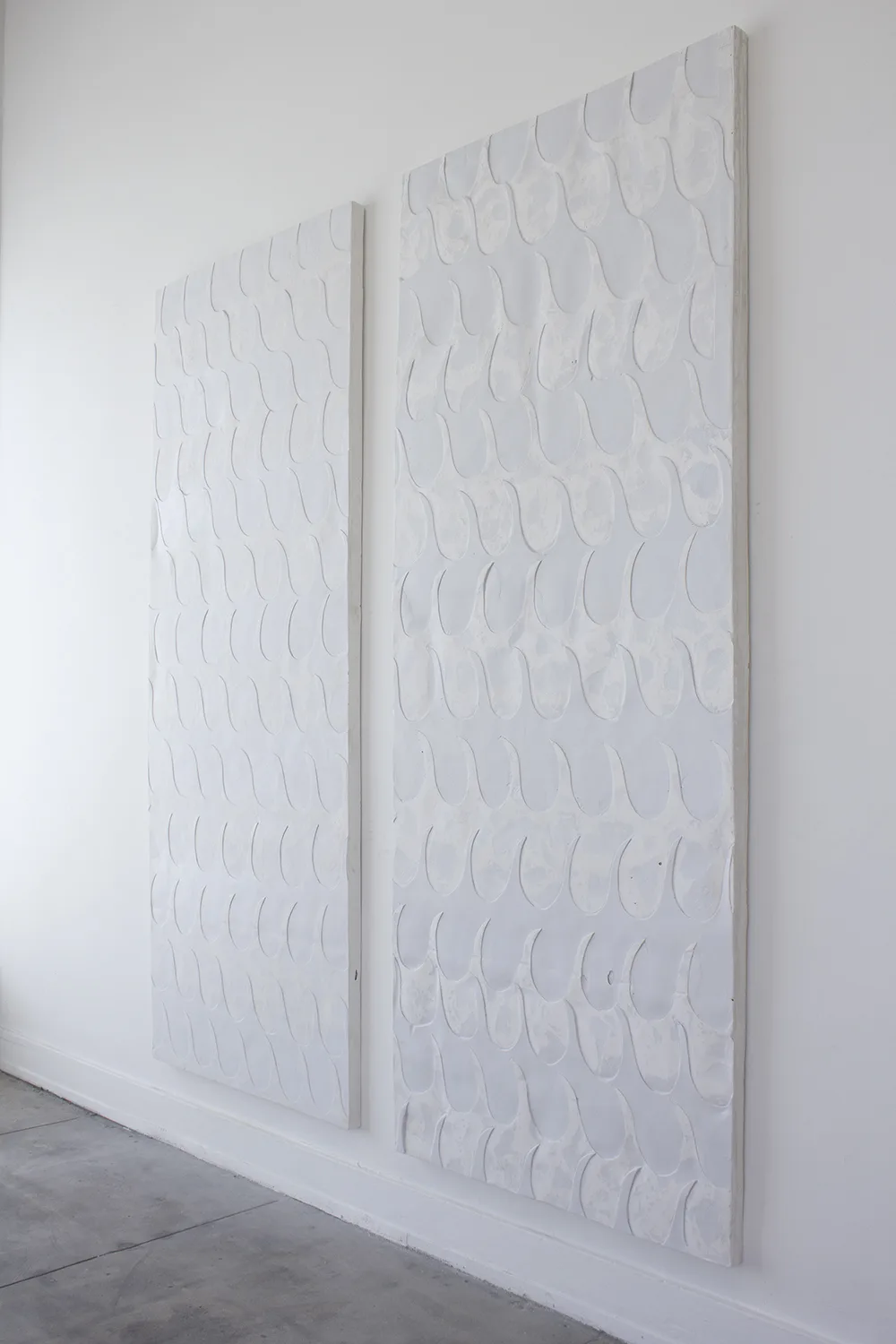 Side view of The Letdown, 2017 by Erin Morrison, Enamel on gypsum cement 33.5 x 87 inches (Two Panels)