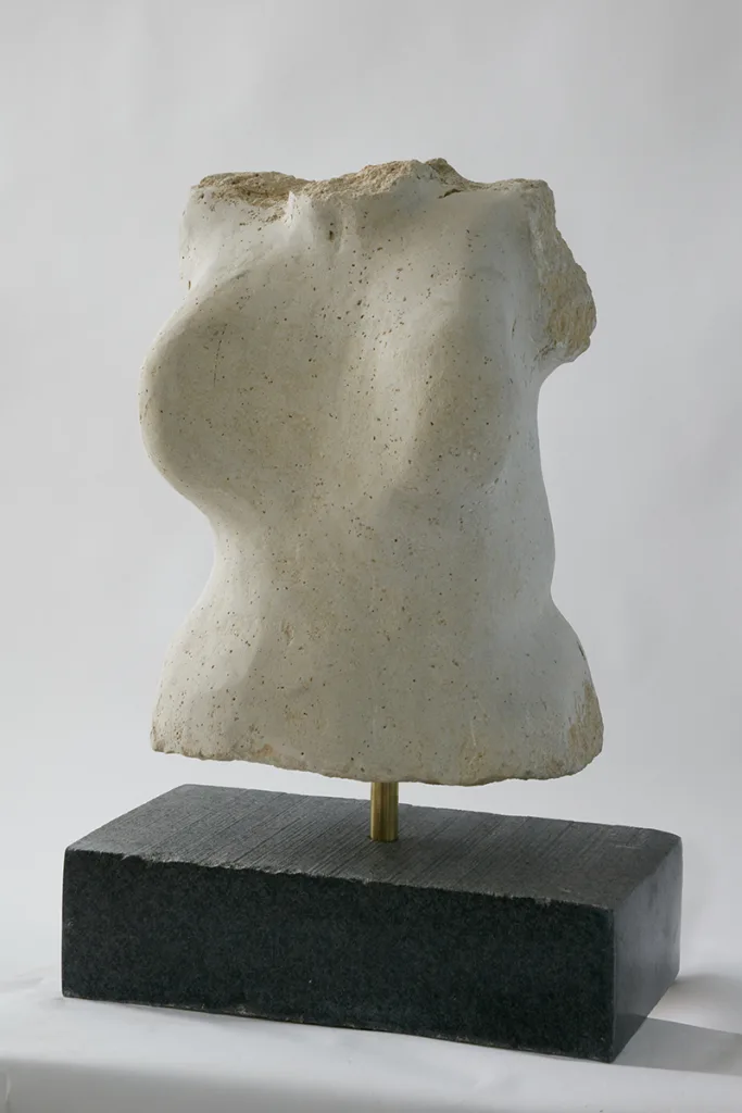 A white sculpture of female torso