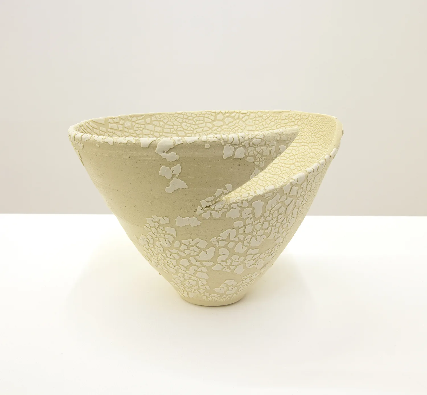 A ceramic that shows a cracked surfaces resembling reptilian scales or lichen.