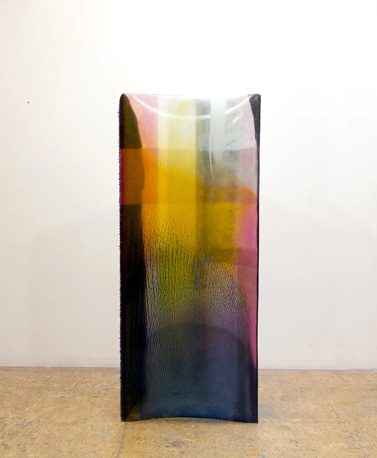 A mixed media work that shows different bright and vivid colors laid on the resin