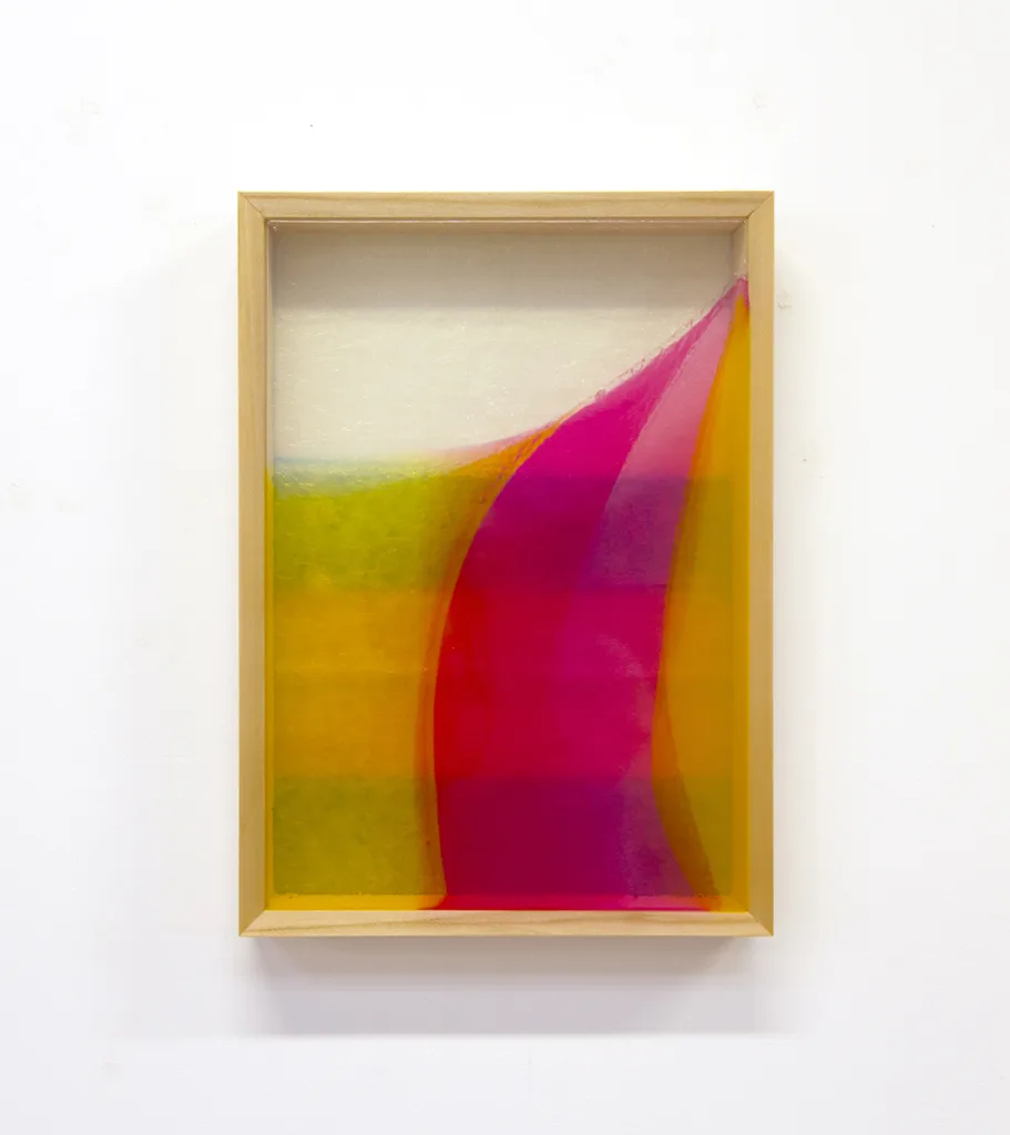 A mixed media work that shows a vibrant colors on a resin