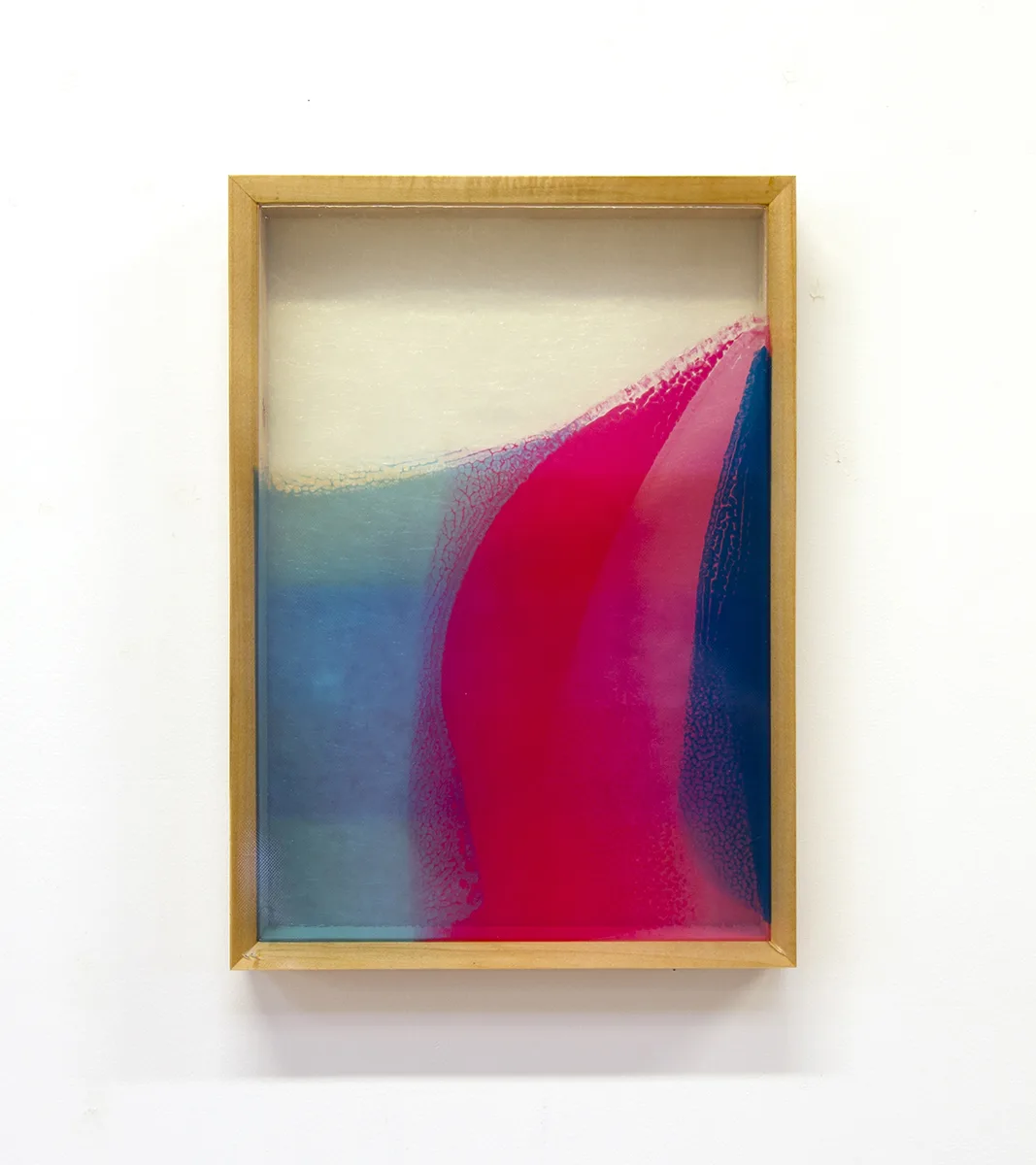 A mixed media work that shows a bright and vivid colors on a resin