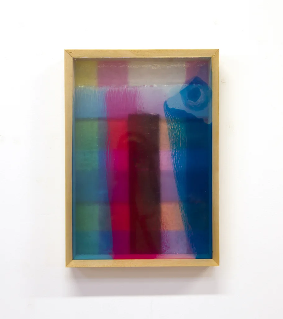 A mixed media work that shows a bright and vivid colors on a resin