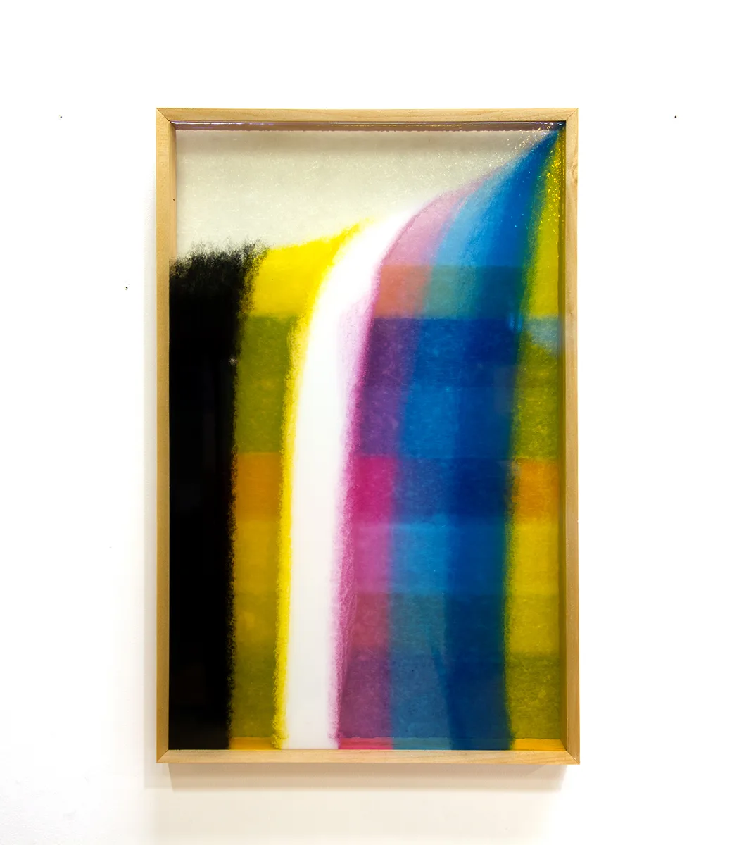 A mixed media work that shows a bright and dark colors on a resin
