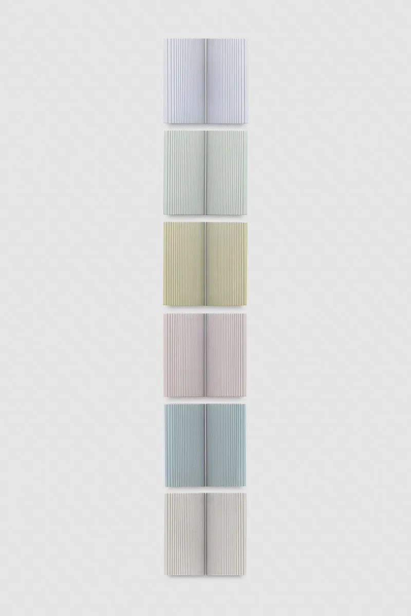 A wall installation that consists of six panels that are painted of pastel colors