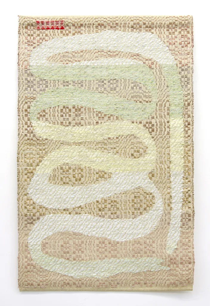 A textile art that shows an ouroboros which is an ancient symbol depicting a serpent or dragon eating its own tail