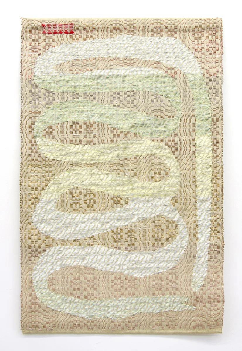 A textile art that shows an ouroboros which is an ancient symbol depicting a serpent or dragon eating its own tail
