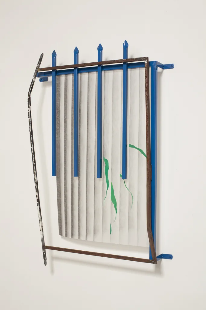 A wall installation that shows a rusted steel and coated steel that is assemble like a window