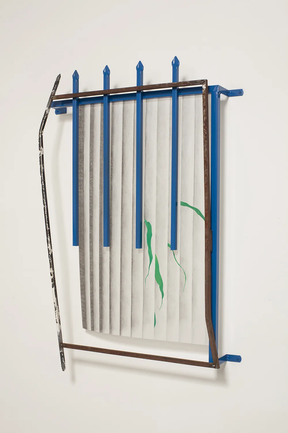 A wall installation that shows a rusted steel and coated steel that is assemble like a window