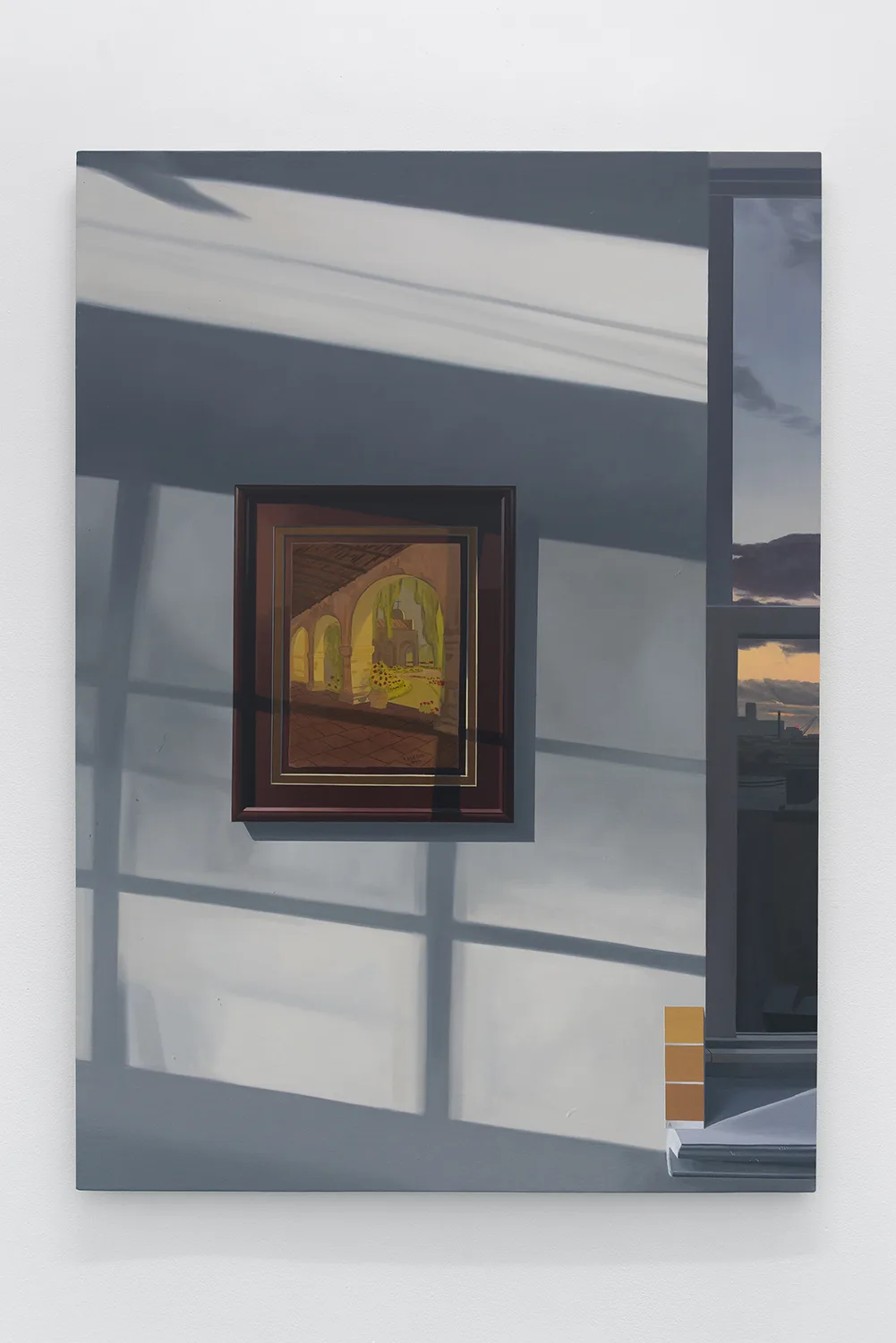 A painting hanging on a wall while there's window shadow