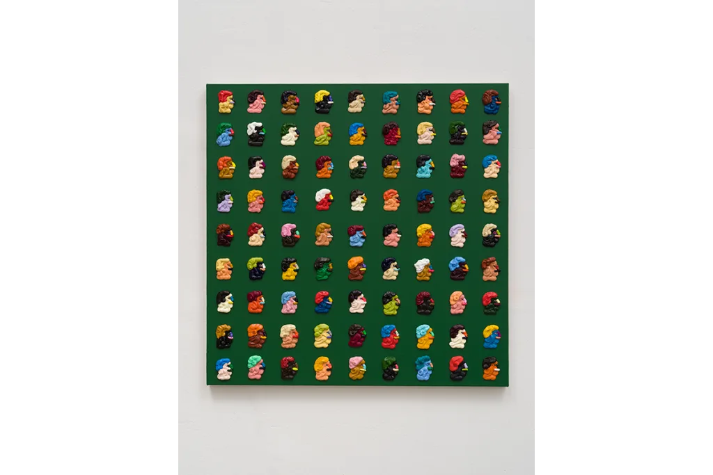 A painting featuring small, and distilled images of faces. The canvas is green