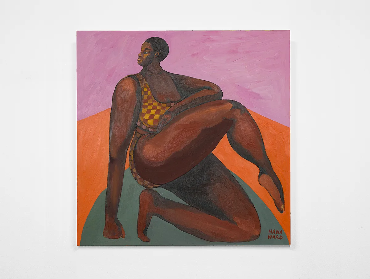 A dark skinned woman is on her left knee