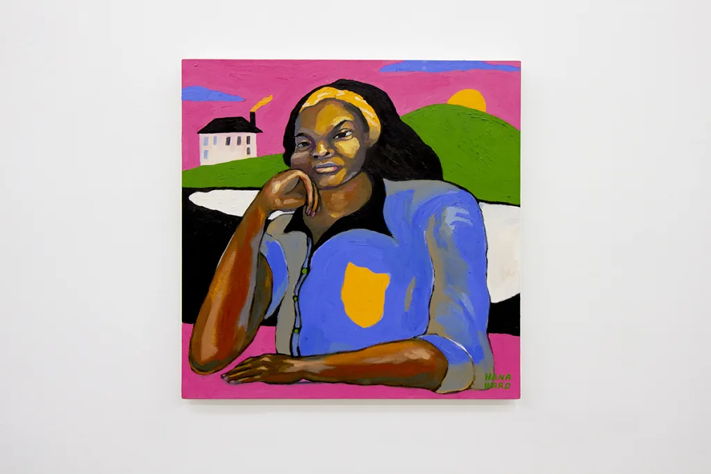 A dark-skinned woman with her chin leaning on her right hand as if daydreaming