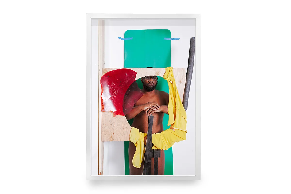 A dark skinned man is undraped and also standing in the middle of the portrait