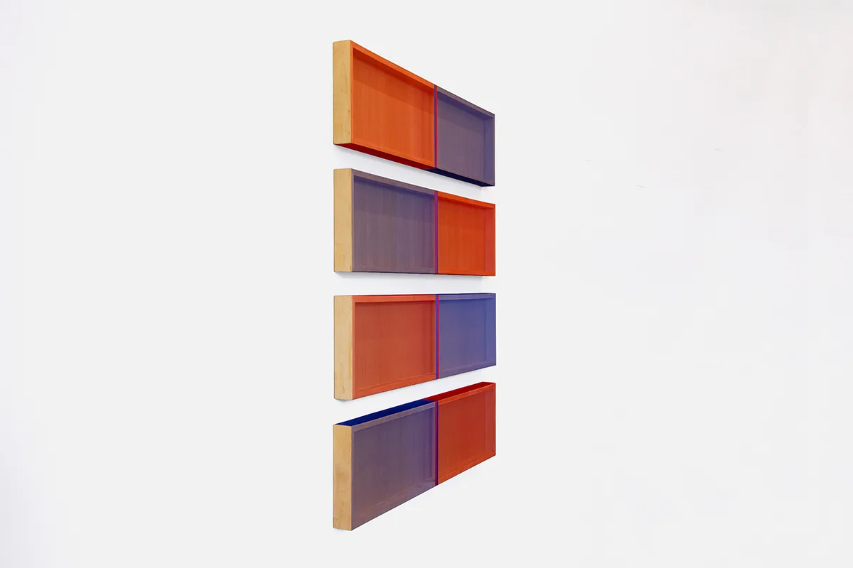 A side view image of a wall installation that consists of four panels that are painted of earth tone colors