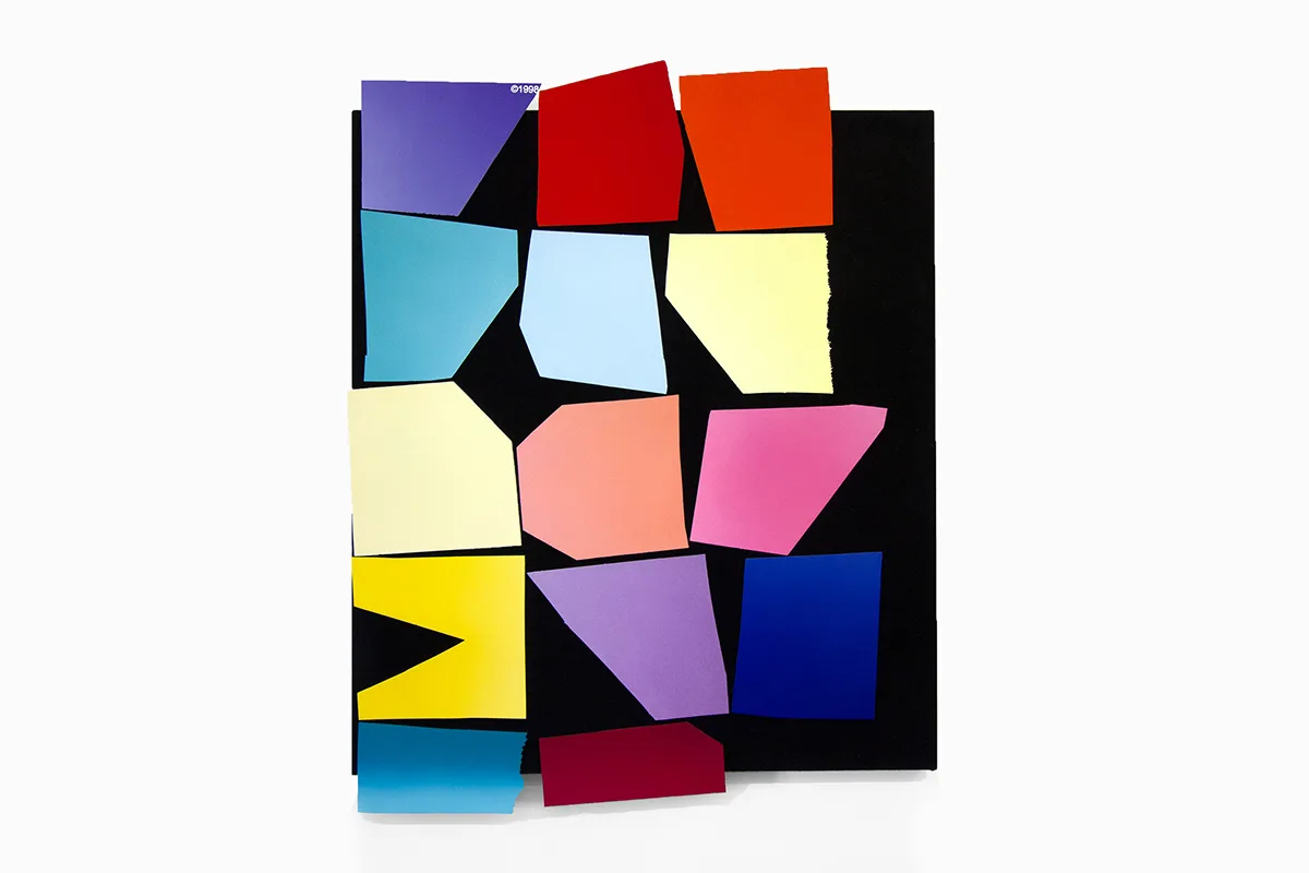 A work that features a black panel that has a multi colors of bright and vivid papers collage on the surface