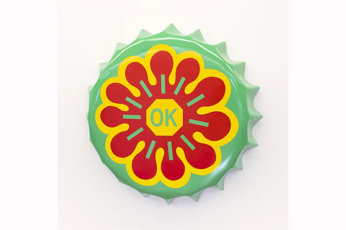 A metal cap-shaped painting shows a text on the middle that states "OK"