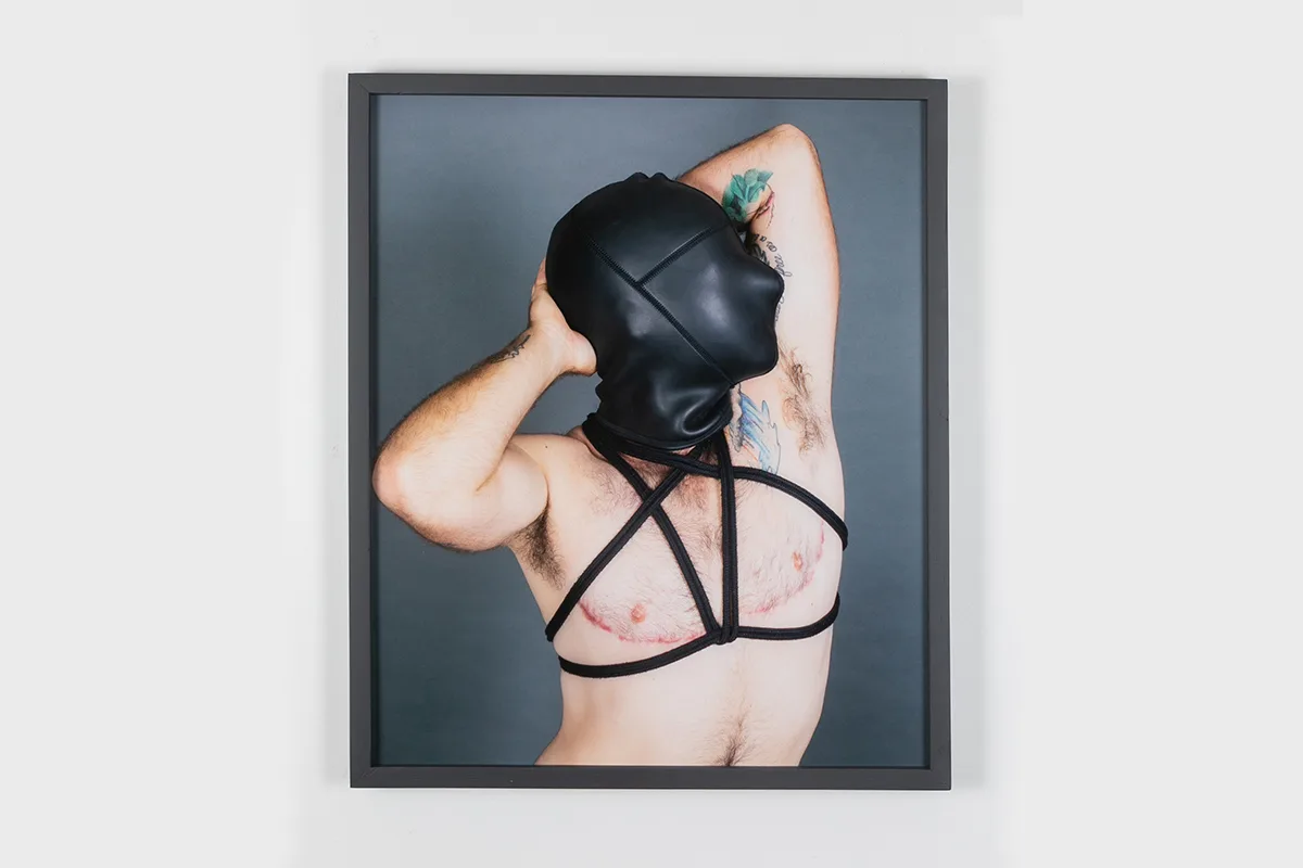 A photo of a man wearing a fetish lack mask