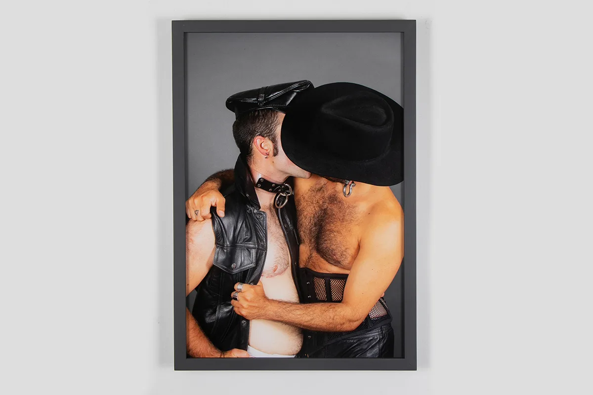 A two human figures who are hugging and kissing, they lock eyes and hold each other firmly