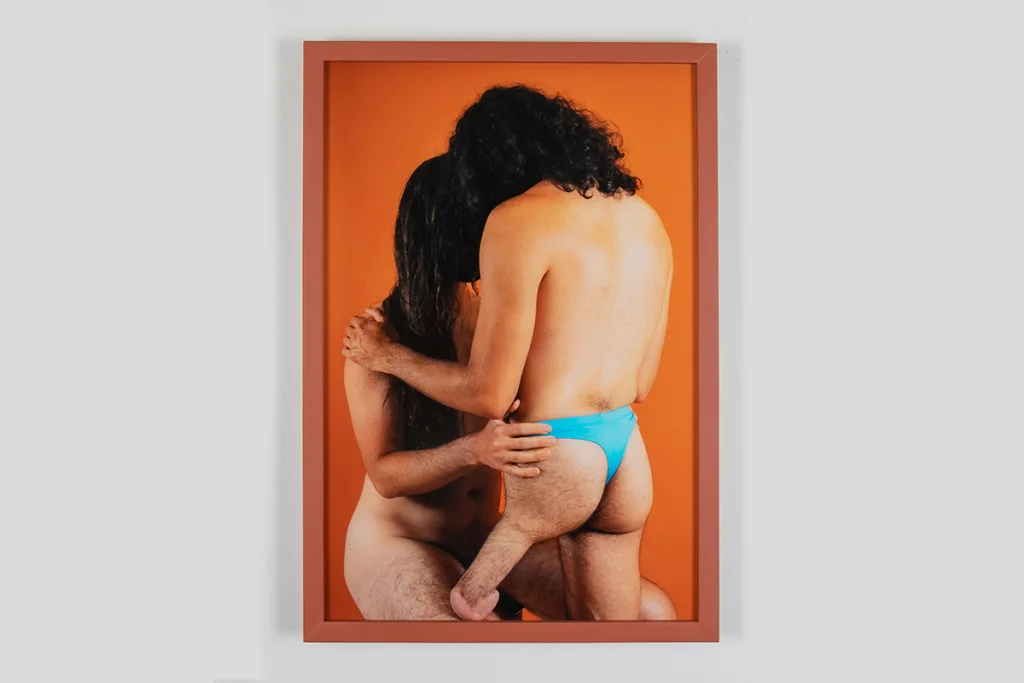 A photo of two male figures who are locking their eyes and holding each other firmly