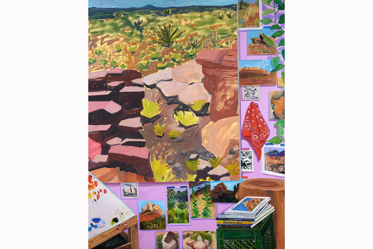 A painting by artist Anna Valdez of her painting studio. Photo references and other paintings on the wall, books on milk crates, and a painting table with a color palette on it.