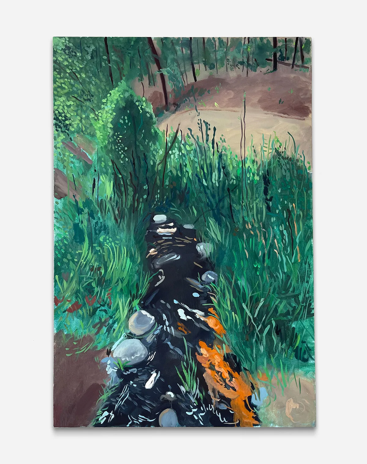 A black stream is channeled by tall grass
