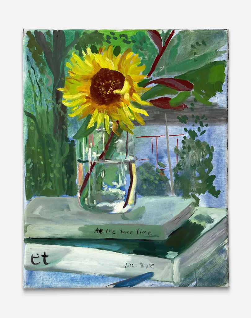 a yellow sunflower in a clear mason jar on top of two books