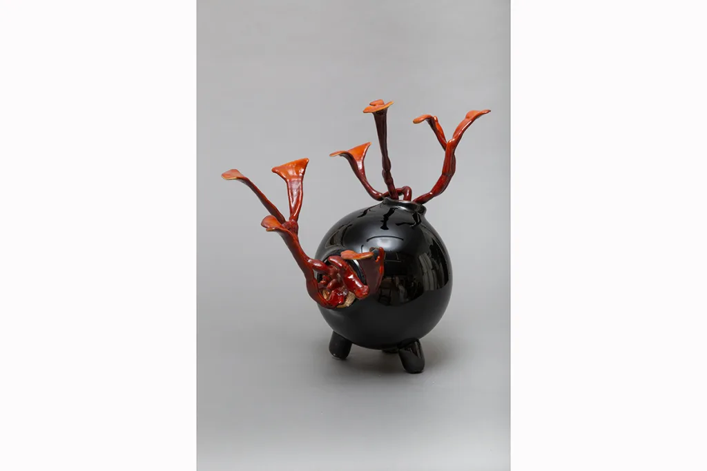 Image of a Sam Shoemaker piece featuring mushrooms sprouting out of a ceramic vessel