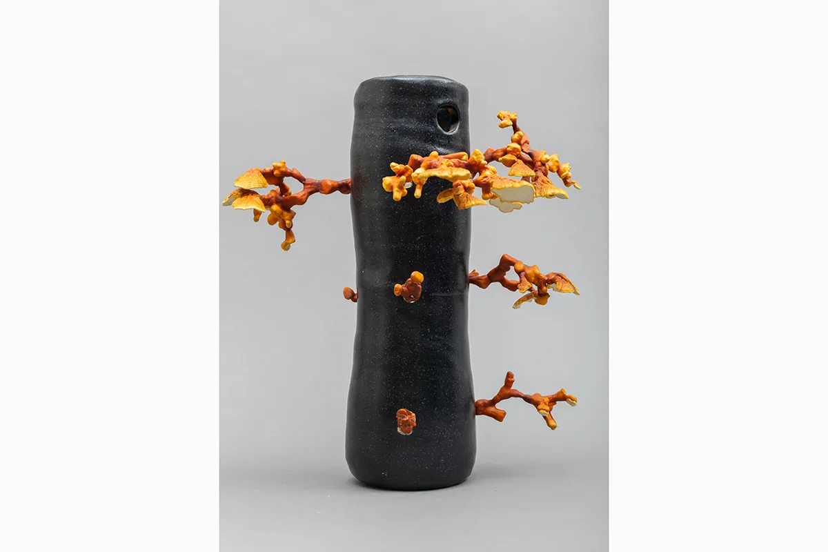 Image of a Sam Shoemaker piece featuring mushrooms sprouting out of a ceramic vessel