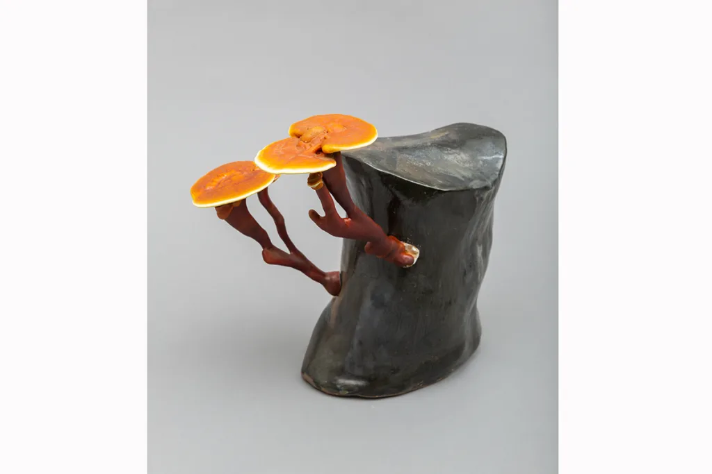 Image of a Sam Shoemaker piece featuring mushrooms sprouting out of a ceramic vessel