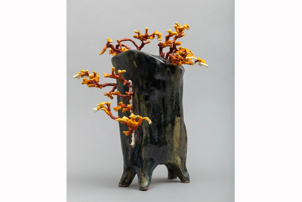 Image of a Sam Shoemaker piece featuring mushrooms sprouting out of a ceramic vessel