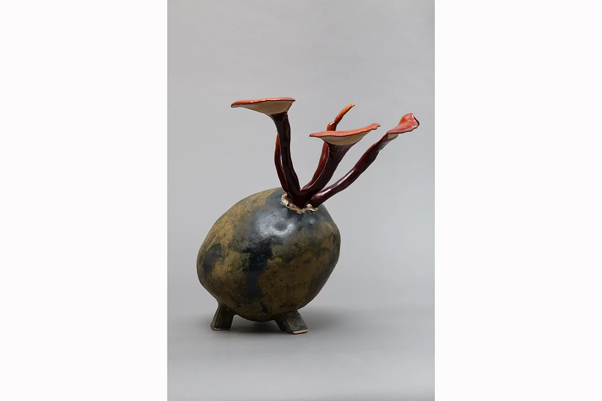 Image of a Sam Shoemaker piece featuring mushrooms sprouting out of a ceramic vessel