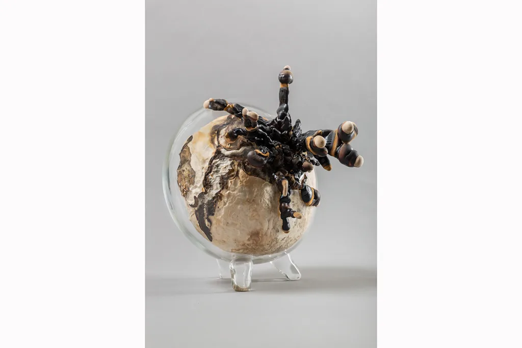 Image of a Sam Shoemaker piece featuring mushrooms sprouting out of a ceramic vessel