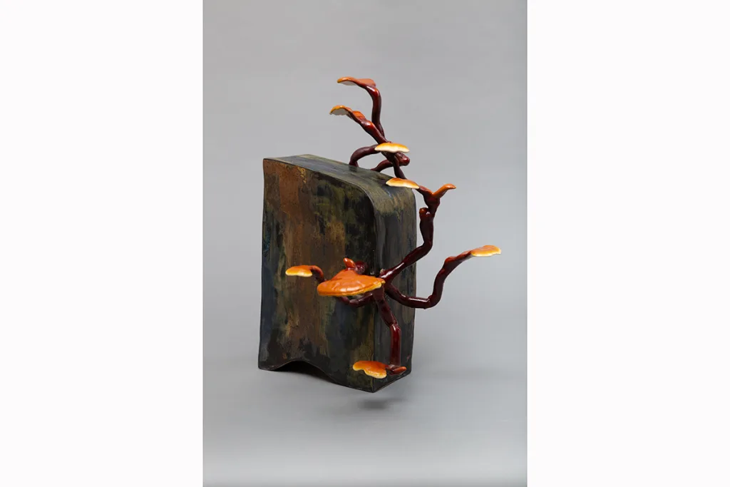 Image of a Sam Shoemaker piece featuring mushrooms sprouting out of a ceramic vessel