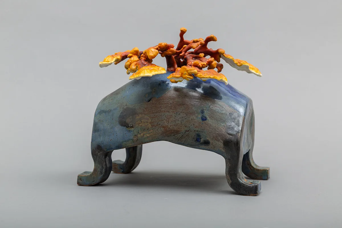Image of a Sam Shoemaker piece featuring mushrooms sprouting out of a ceramic vessel